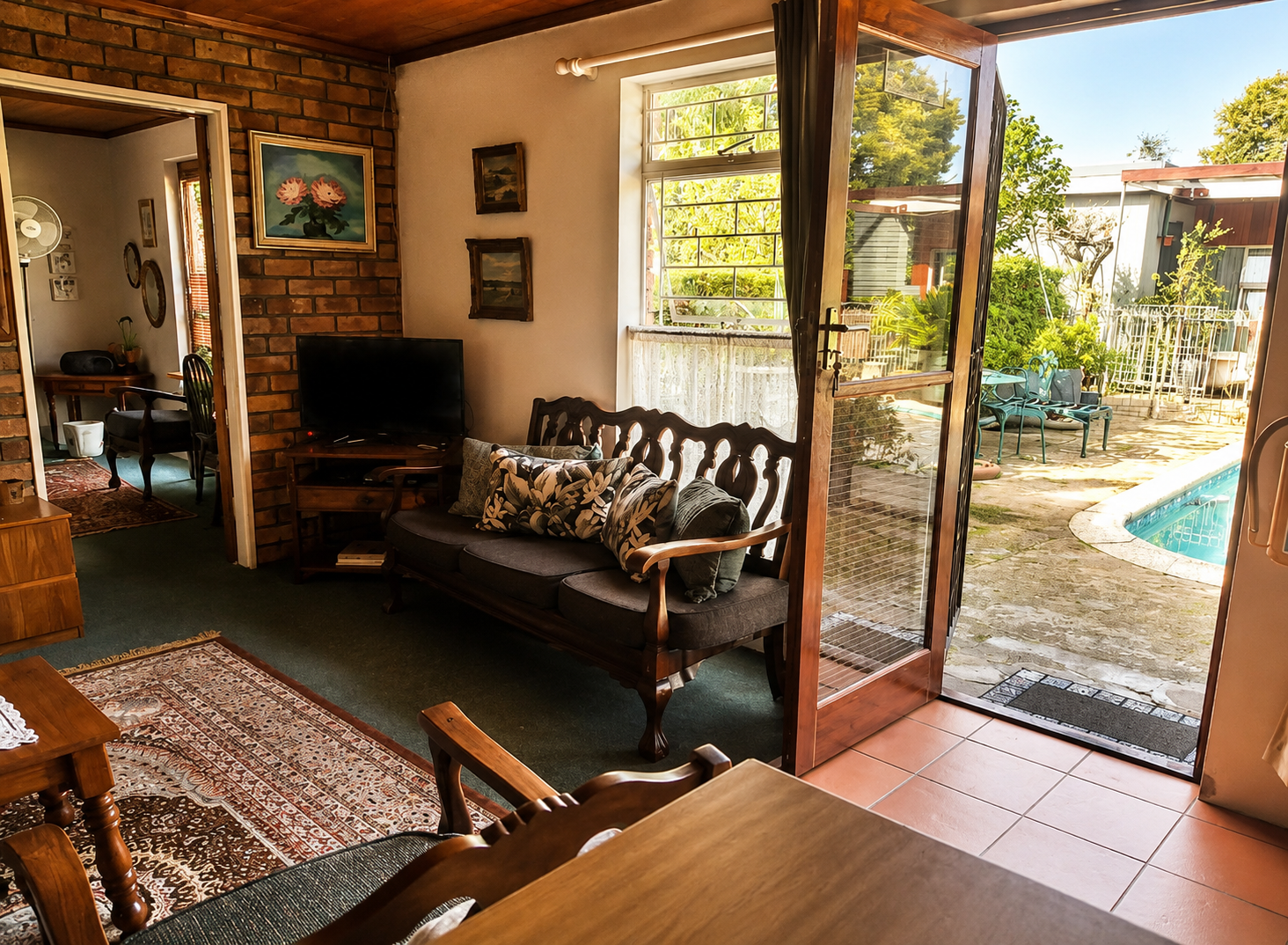 Warm Protea Suite lounge with private garden courtyard access in Durbanville